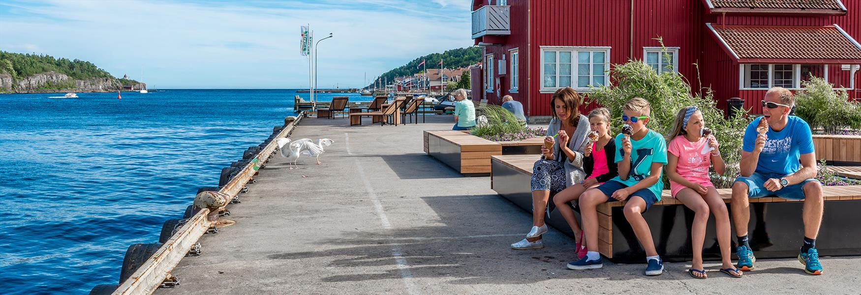 family sits on the pier at Langesund and eats ice cream
