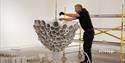 Kunsthall Grenland En mann monterer en utstilling
