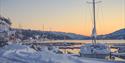Notodden Motorbåtforenings Gjestehavn i vakker solnedgang vinterstid med snø. Foto